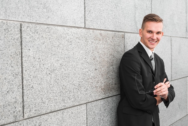 Businessman next to wall