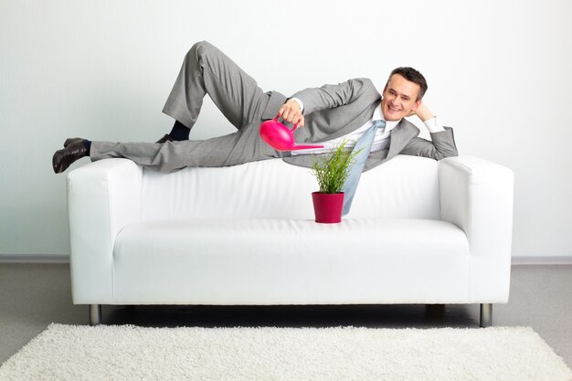 Businessman watering a plant