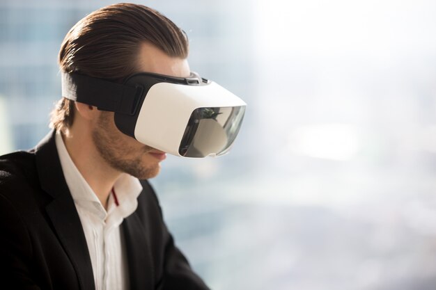 businessman wearing futuristic virtual reality glasses.
