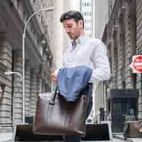 Free photo businessman with bag and cup