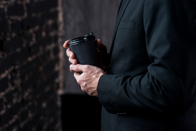 Businessman with coffee in paper cup