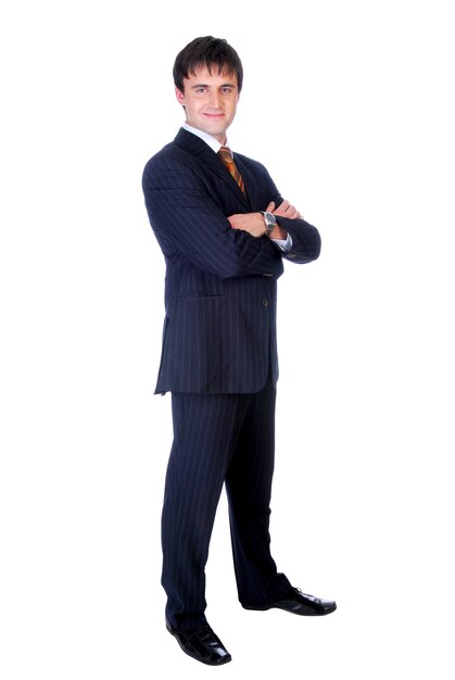 Businessman with crossed hands standing against isolated wall