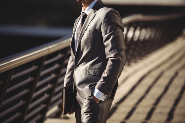 Businessman with a diary standing in the office terrace