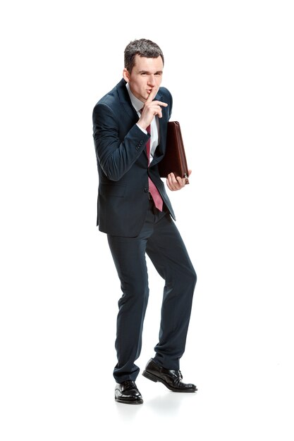 Businessman with folder asking for silence isolated on white wall