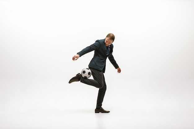 Free photo businessman with football ball in office.