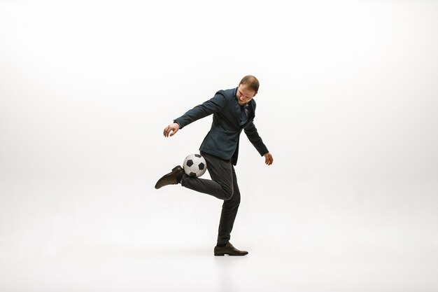 Businessman with football ball in office.