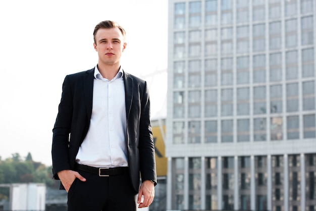 Businessman with hand in pocket looking at camera