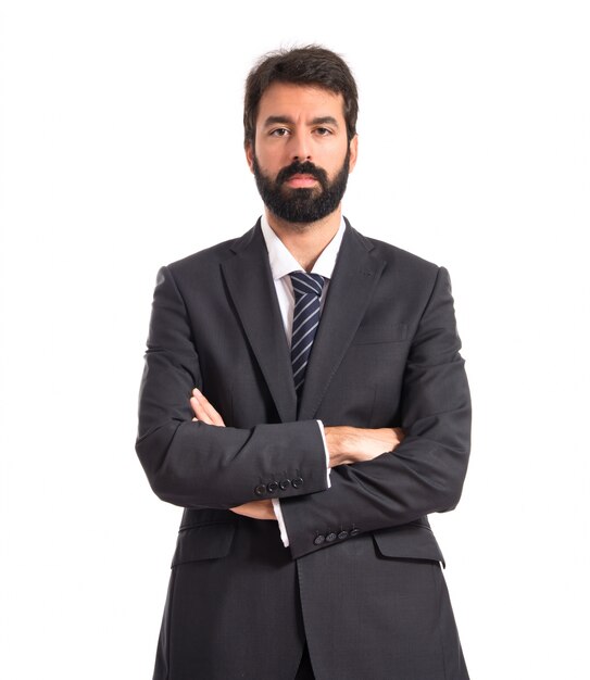 Businessman with his arms crossed over white background