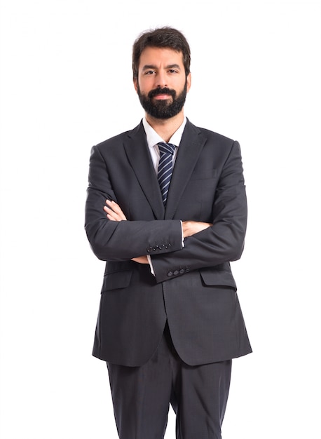 Businessman with his arms crossed over white background