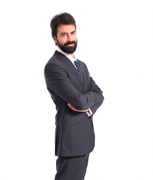 Businessman with his arms crossed over white background