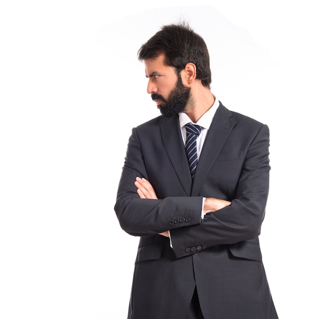 Businessman with his arms crossed over white background