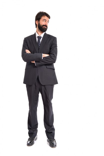 Businessman with his arms crossed over white background