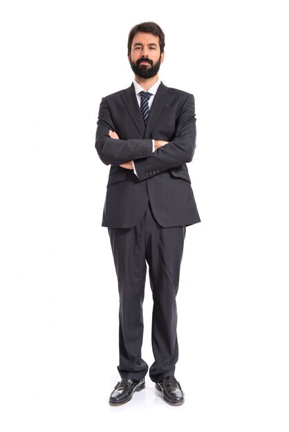 Businessman with his arms crossed over white background