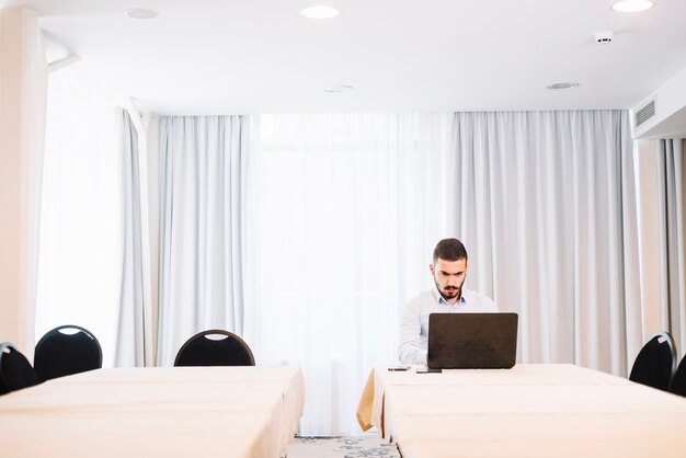 Businessman with laptop at table