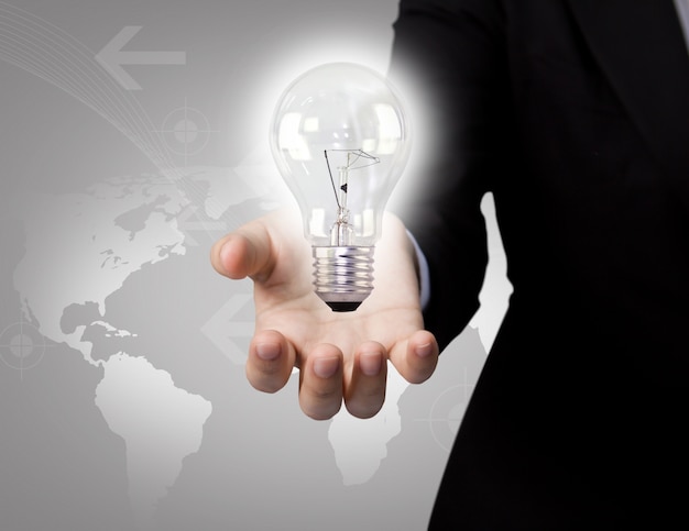 Businessman with light bulb and map background