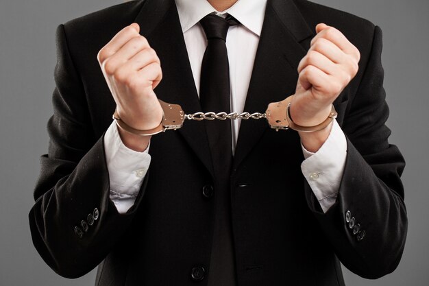 Businessman with manacles on his hands