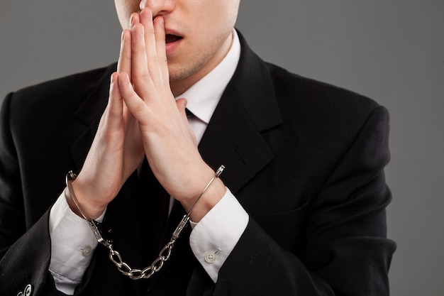 Businessman with manacles on his hands