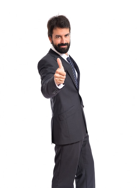 Businessman with thumb up over white background