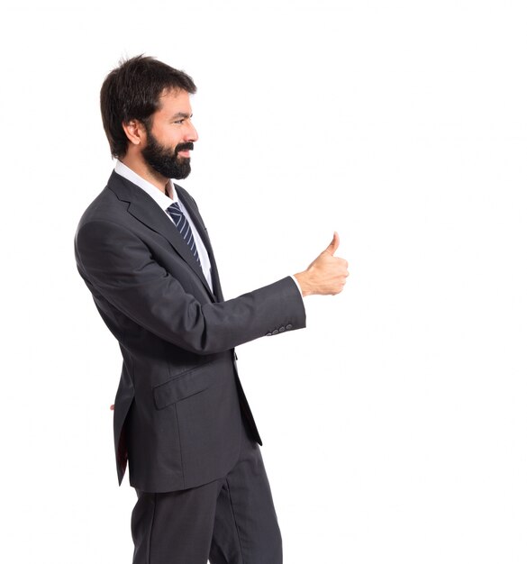 Businessman with thumb up over white background