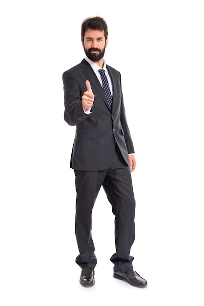 Businessman with thumb up over white background