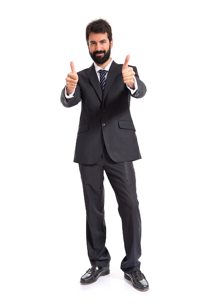 Businessman with thumb up over white background