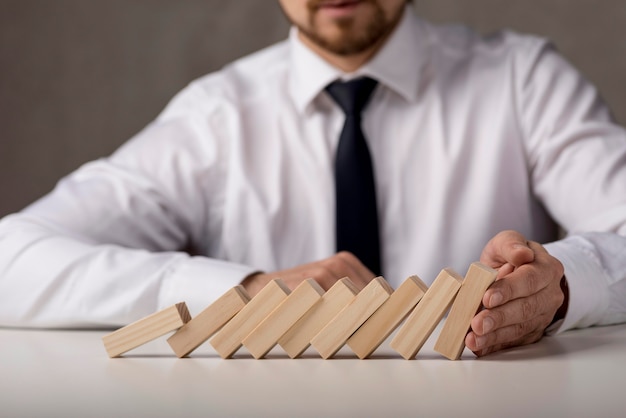 Free photo businessman with tie and dominoes