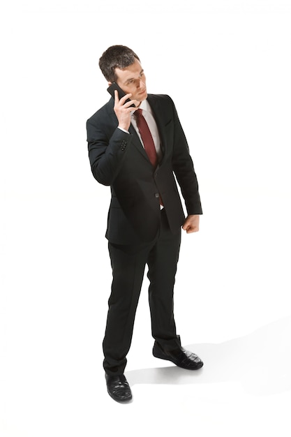 Businessman with very serious face and talking on the phone