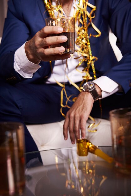 businessman with whiskey at night club