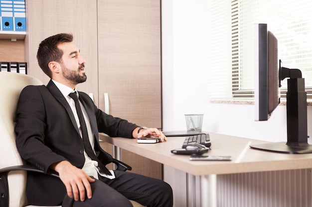 Businessman working in his office. Businessperson in professional environment