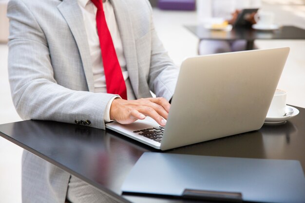 Businessman working on laptop in cafe