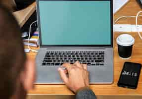 Free photo businessman working on a laptop a during meeting