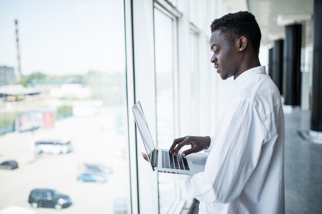 Businessman working on laptop in modern office