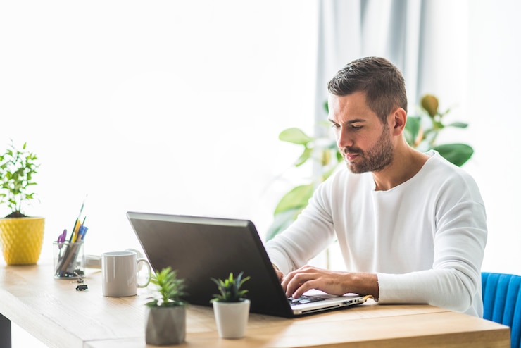 Free Photo businessman working on laptop
