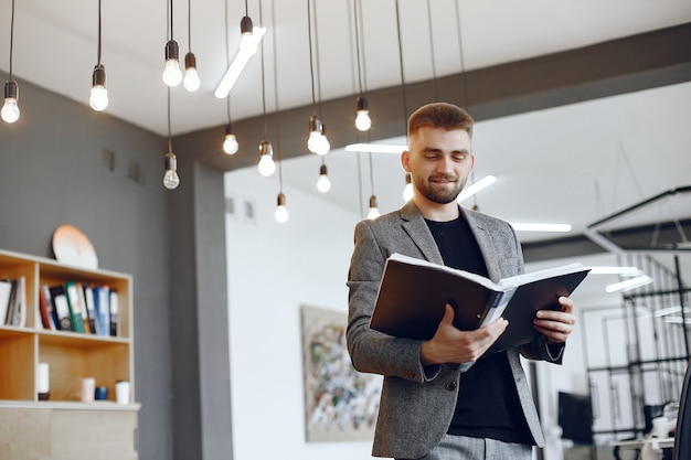 Businessman working in the office.Man  holds a folder. Guy is sitting in the office