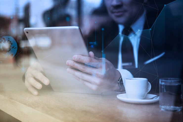 Free Photo businessman working on tablet in cafe