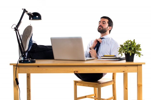 Free photo businessman working with laptot in his office