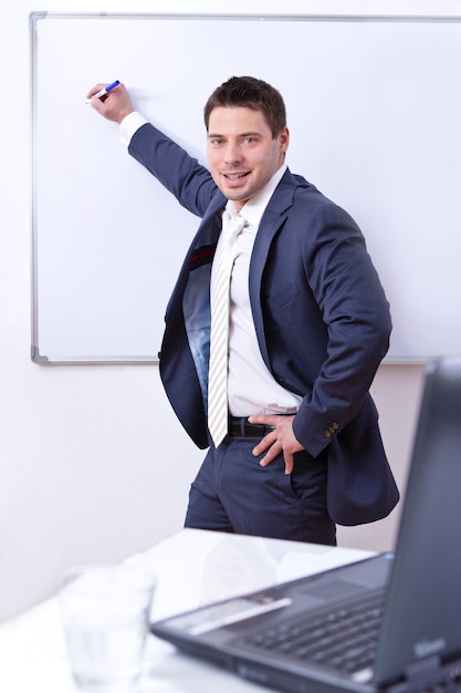 Businessman writing on board