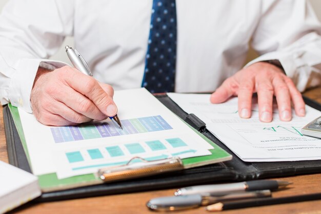 Businessman writing on documents