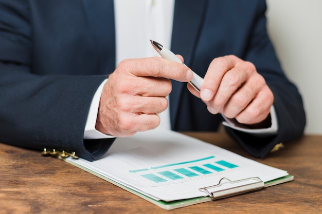 Businessman writing on documents