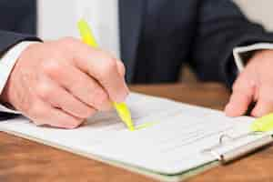 Free photo businessman writing on documents