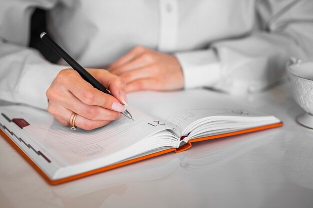 Businessman writing into notebook