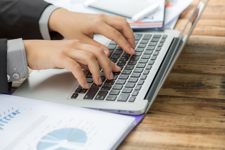 Free Photo businessman writing on a laptop