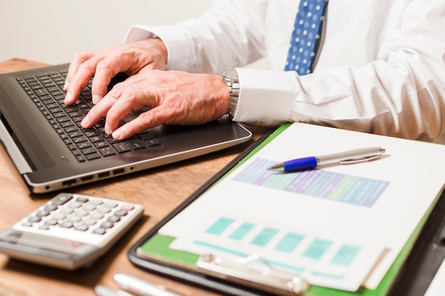 Businessman writing on laptop