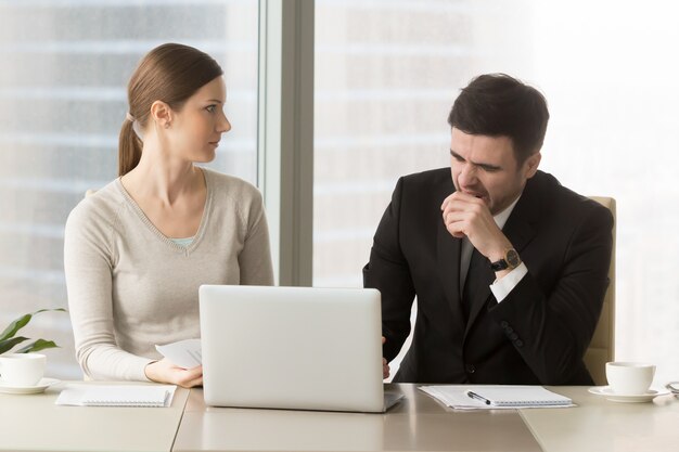 Businessman yawning on boring business meeting