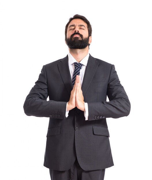 Businessman in zen position over white background