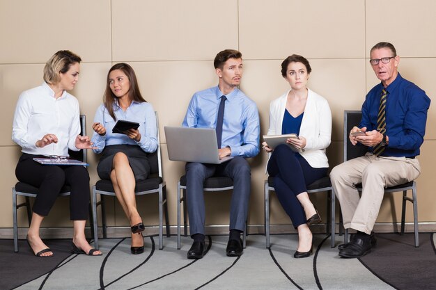 Businessmen and Businesswomen Sitting and Waiting