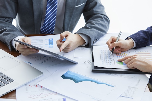 Businessmen in elegant suits at a business meeting discussing a new project in the office