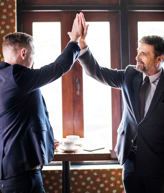 Free photo businessmen giving a high five