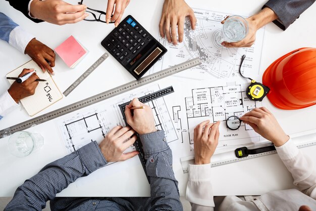 businessmen hands on white table with documents and drafts