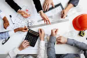 Free photo businessmen hands on white table with documents and drafts